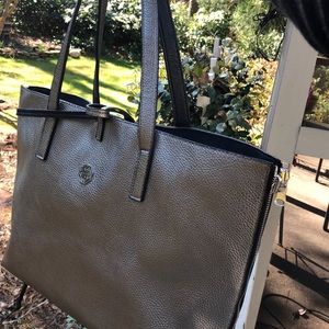 Pewter colored handbag  stylish zipper around bag.